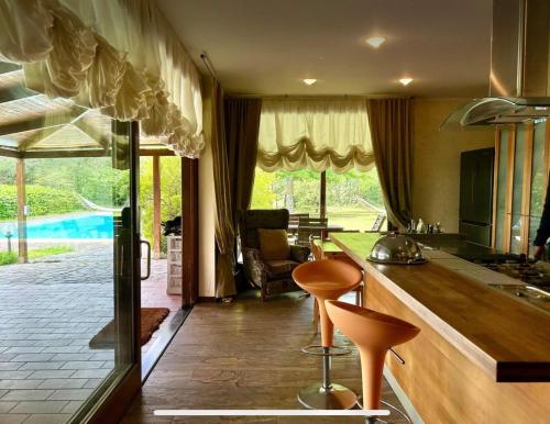 a kitchen with a counter and two stools in it at Villa Elena in Montefiascone