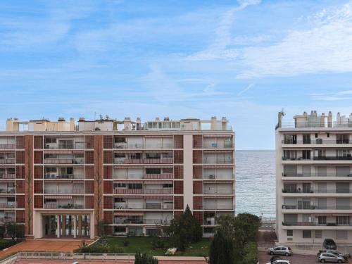 Deux grands bâtiments à côté de l'océan et de l'océan dans l'établissement Apartment Le Bonaparte by Interhome, à Roquebrune-Cap-Martin