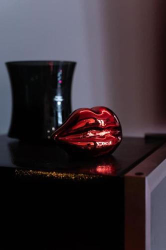 a red sculpture sitting on top of a table at La Royale Room in Épernay