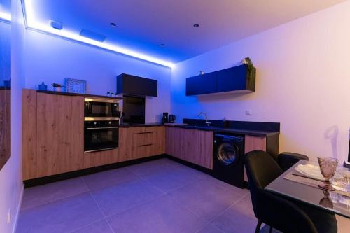 a kitchen with a washer in the middle of it at La Royale Room in Épernay
