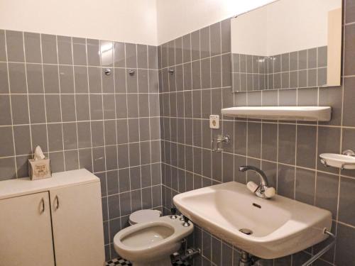 a bathroom with a sink and a toilet at Apartment Marigny Dent-Blanche 25 by Interhome in Crans-Montana