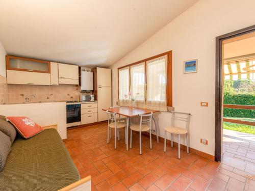 a kitchen with a table and chairs in a room at Holiday Home Rosa by Interhome in Pian dʼAlma