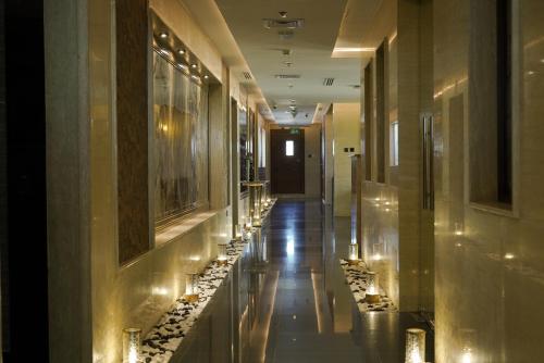 a hallway in a building with lights on the walls at La Zona Continental Hotel in Dubai