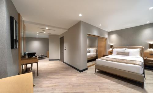 a hotel room with a bed and a desk and a bedroom at Me by Mula in Istanbul