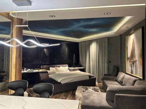 a bedroom with a bed and a living room at Upgraded Studio at Bab Al Bahr in Ras al Khaimah