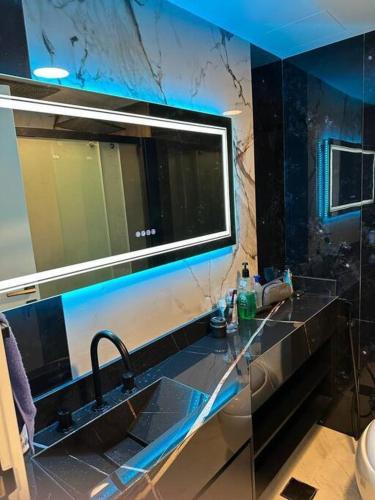 a bathroom with a sink and a large mirror at Upgraded Studio at Bab Al Bahr in Ras al Khaimah