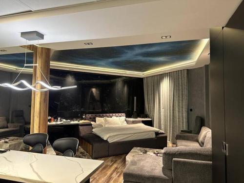a bedroom with a bed and a table and chairs at Upgraded Studio at Bab Al Bahr in Ras al Khaimah