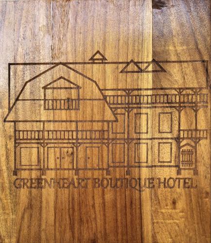a drawing of a house on a wooden table at Greenheart Boutique Hotel in Paramaribo