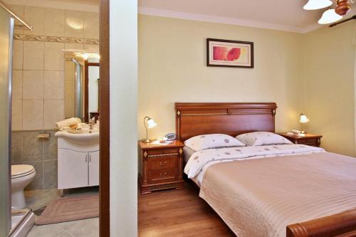 a bedroom with a bed and a sink and a toilet at Apartments Ivanka C. in Soline
