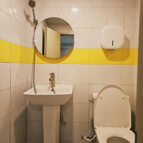a bathroom with a sink and a toilet and a mirror at Stay Aall Seoul Train Station 2 in Seoul
