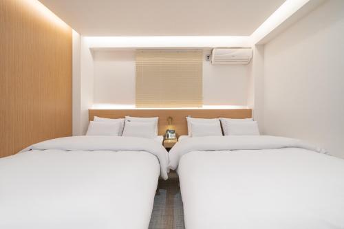 Postel nebo postele na pokoji v ubytování Hotel YAJA Namchuncheon