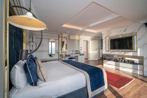 a bedroom with a large bed and a television at The Byzantium Suites Hotel & Spa in Istanbul
