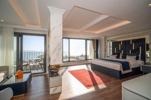 a bedroom with a large bed and a balcony at The Byzantium Suites Hotel & Spa in Istanbul