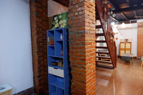 a brick wall with blue drawers next to a brick column at Mekong view House in Luangprabang in Luang Prabang