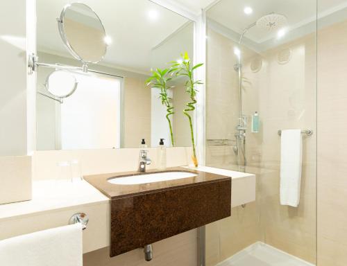 a bathroom with a sink and a large mirror at HOVIMA Costa Adeje - For Cool Adults in Adeje