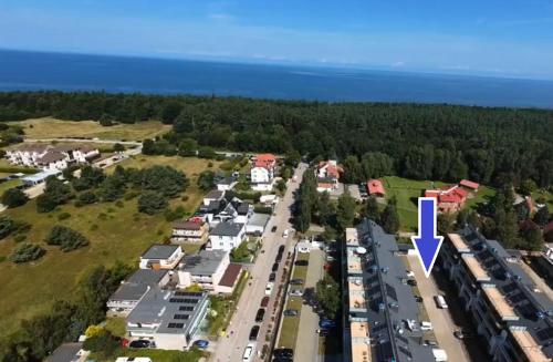 an aerial view of a parking lot with a blue arrow at POSESJA APARTAMENTY & SPA - Posesja Plażowa 4a III in Grzybowo