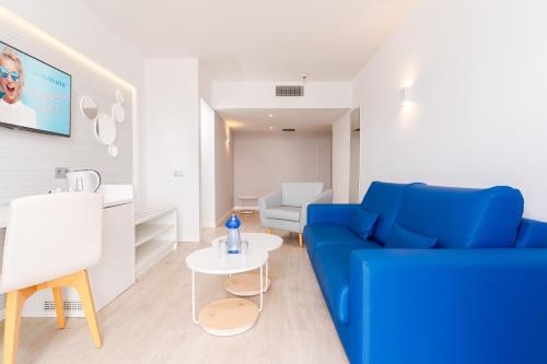 a living room with a blue couch and a table at HOVIMA Costa Adeje - For Cool Adults in Adeje