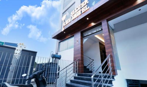 a building with a motorcycle parked outside of it at Itsy Hotels Silver Keys in Bengaluru