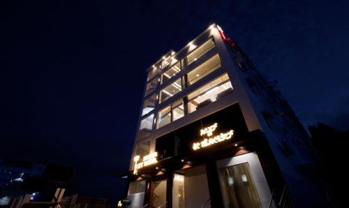 a tall building with a sign on it at night at Itsy Hotels Silver Keys in Bengaluru