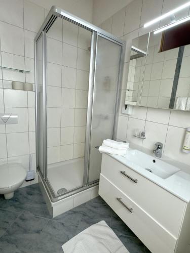 a bathroom with a shower and a sink and a toilet at Landhaus Lechthaler in Sankt Anton am Arlberg