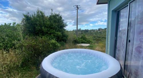 a large bath tub sitting outside of a window at Alma Mía in Villa Serrana