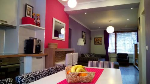 a kitchen with a table with a basket of fruit on it at Parkview Apartments in Sofia