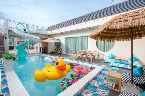 a pool with a inflatable rubber duck in the water at Cloud9 Pool Villa in Cha Am