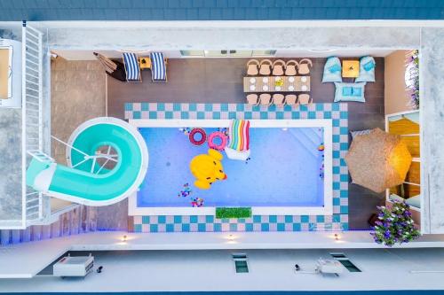 a toy house with a pool and a swimming pool at Cloud9 Pool Villa in Cha Am