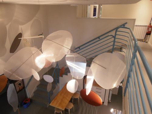 a bunch of umbrellas hanging from a staircase at Plaza Catedral hostel in Pamplona
