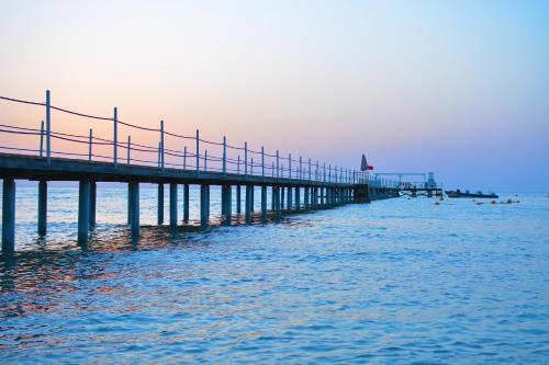 a pier stretches out over the water in the ocean at Sataya Resort Marsa Alam in Marsa Alam City
