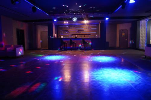 a room with a stage with chairs and lights at Sataya Resort Marsa Alam in Marsa Alam City