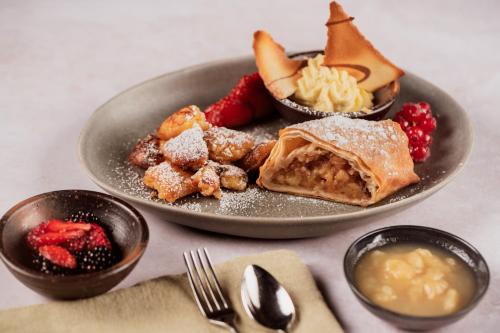 a plate of food with desserts on a table at Staudacherhof in Garmisch-Partenkirchen I Blick aufs Zugspitzmassiv I einzigartige Bayurvida Küche in Garmisch-Partenkirchen