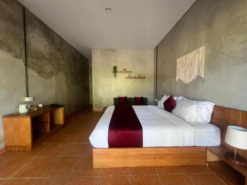 a bedroom with a large bed in a room at Keramas temuku family Guest house in Gianyar