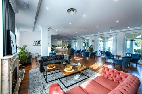 a living room with couches and a table at Hotel Tamisa Golf in Mijas