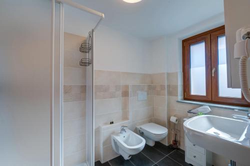 a bathroom with a toilet and a sink and a shower at Il Girasole Bed and Breakfast in Donnas