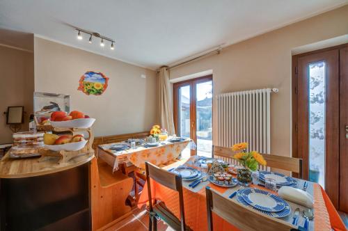 a kitchen and dining room with a table and chairs at Il Girasole Bed and Breakfast in Donnas
