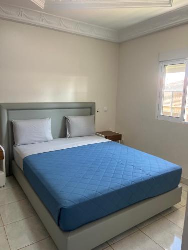 a bed in a white room with a blue mattress at MAG Palace Hotel in Bissau