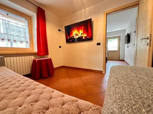 a bedroom with a fire in a tv on the wall at Sunrise Livigno in Livigno