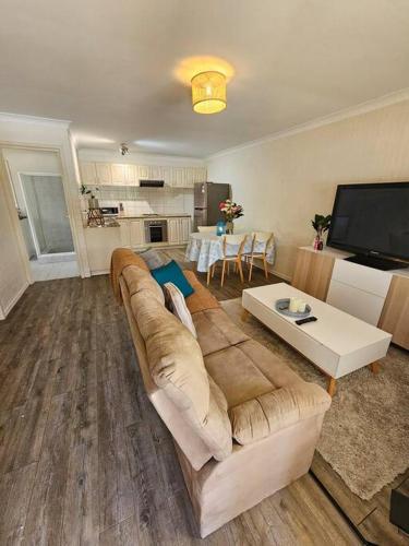 a living room with a couch and a tv at Sandringham Tranquil Retreat in Perth