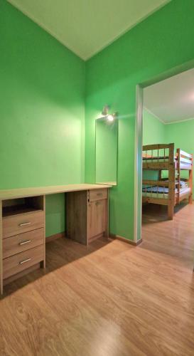 a green room with a desk and a bunk bed at Vinni Sport & Spa hostel in Vinni