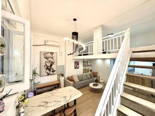 a living room with a staircase and a couch at Tonight Homestay West Nanjing Road Shanghai in Shanghai