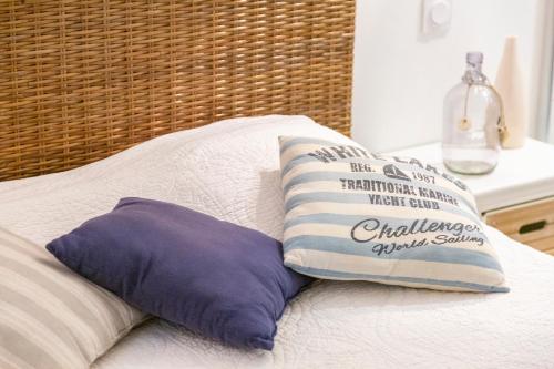 a bed with two pillows on top of it at Grand Loft plein centre Concarneau in Concarneau