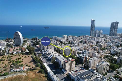 an aerial view of a city with a blue circle at Melia Suites in Limassol