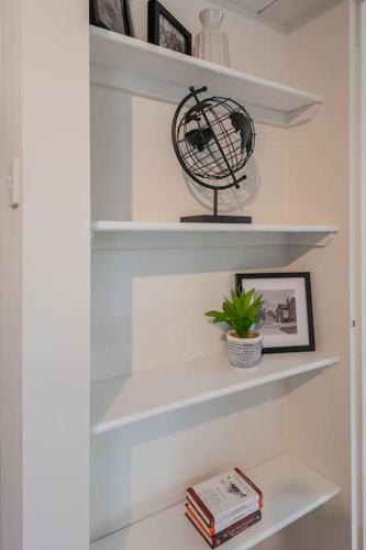 a shelf with a globe and a plant on it at Chapel Lodge in Ambleside