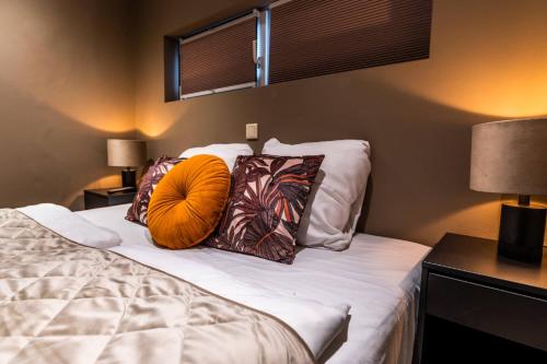 a bedroom with a bed with two pillows on it at Vakantiewoning Plantage 40 in Bruinisse