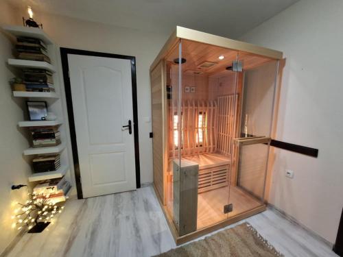 a walk in shower in a room with a door at Aura house in Dolna Banya