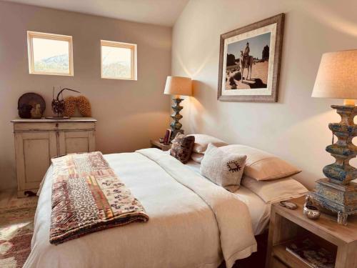 a bedroom with a bed and a picture on the wall at CASA TUA SANTA FE - NM Farmhouse Sanctuary Soaking Room 1 acre private in Santa Fe