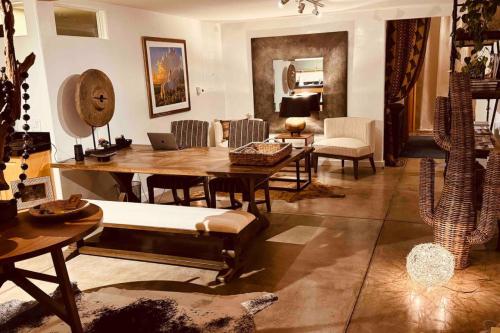 a living room with a wooden table and chairs at CASA TUA SANTA FE 2BR 2BA Design Loft Yoga studio Outdoor Living in Santa Fe