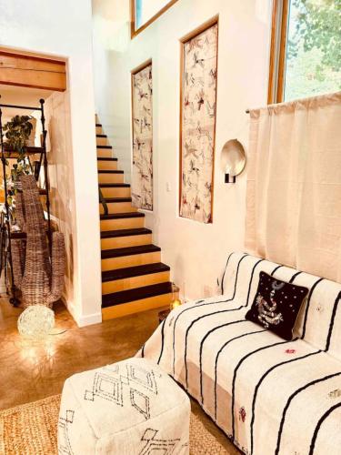 a living room with a couch and a staircase at CASA TUA SANTA FE 2BR 2BA Design Loft Yoga studio Outdoor Living in Santa Fe