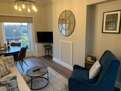 a living room with a couch and a table at The Auction House in Belfast